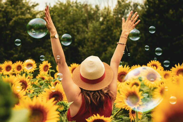 Happy woman on a field of sunflowers