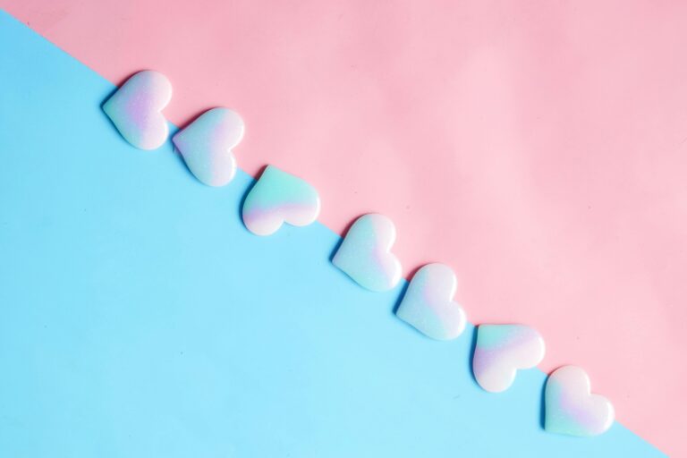 Pastel hearts on blue and pink background representing the power of 5 minute rituals for self-love and daily transformation