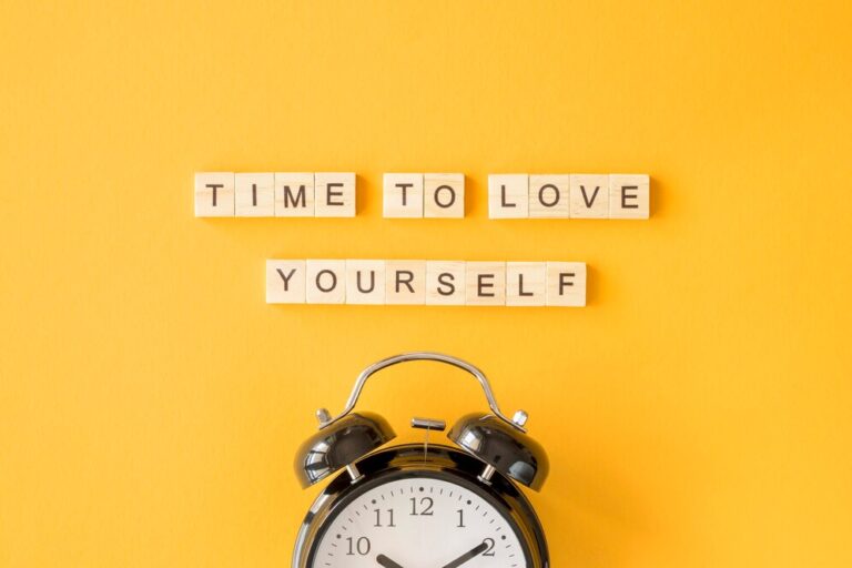 Colorful letter blocks spelling time to love yourself representing 5 minute self-love rituals